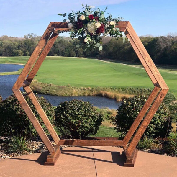 Hexagon-shaped wooden arch rental for weddings, ideal as a rustic ceremony backdrop or photo centerpiece, customizable with flowers or drapery.