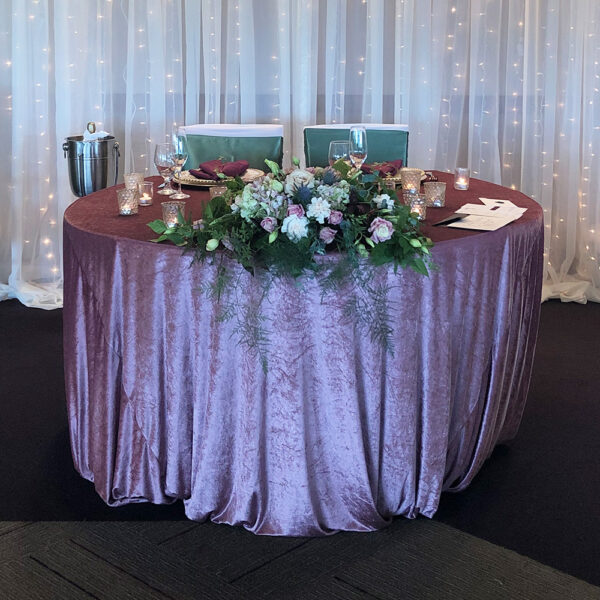 Elegant wedding table set with premium linen tablecloth, adorned with floral centerpieces and accents, ideal for enhancing any wedding theme or reception décor."