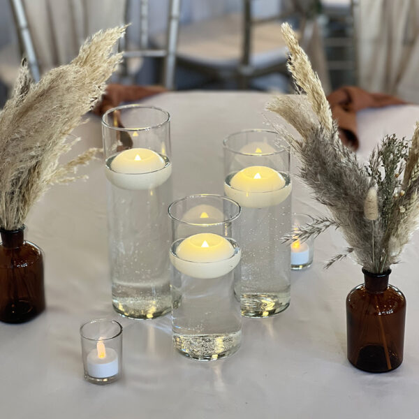 Trio Glass Cylinder Vases for weddings, featuring varying heights for depth and dimension. Ideal for floating candles, flowers, or greenery, adding elegance.